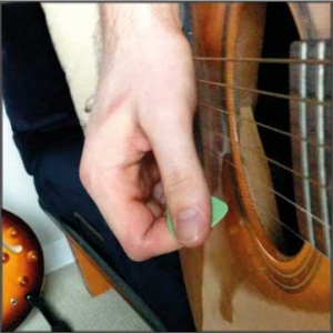 make sure the pick lands below the strings so you can do an upstroke immediately following the slap